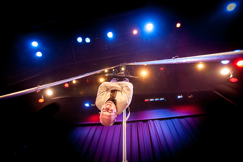 Ian Stewart performing magic in a white jacket